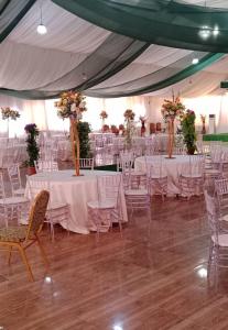 a marquee with white tables and chairs and flowers at NEW VIEW BEACH HOTEL AND RESORT in Lagos
