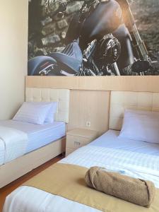 Voodi või voodid majutusasutuse Ayuri Hotel Malioboro toas