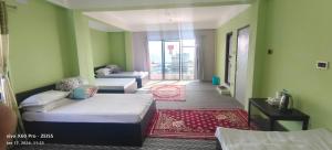 Postelja oz. postelje v sobi nastanitve Hotel TAMU ilam