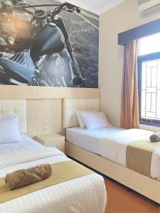 Voodi või voodid majutusasutuse Ayuri Hotel Malioboro toas