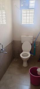 La salle de bains est pourvue de toilettes blanches et d'une fenêtre. dans l'établissement Akshra residency 1 bhk, à Hinjawadi