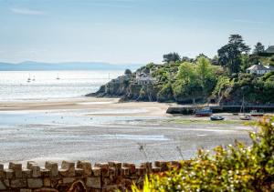 a view of a beach with houses and the ocean at Glanaber Bach in Abersoch