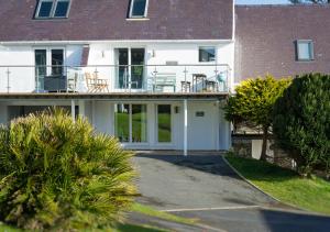 an external view of a house with a porch at St Tudwals View in Abersoch