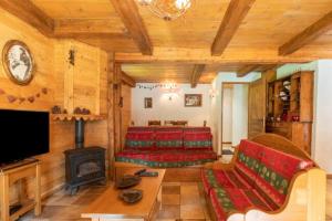 a living room with a couch and a fireplace at CASA-Chalet Brizolée lake-view chalet in Tignes close to ski area in Tignes