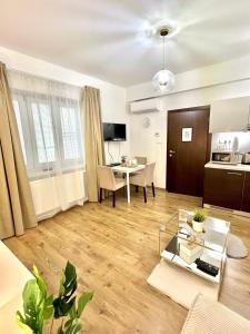 a living room with a table and a kitchen at URBAN JUNGLE Apartment old town Air Conditioned in Bratislava