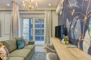 a living room with a couch and a tv at Leone Central Luxury Apartments - Happy Rentals in Zagreb