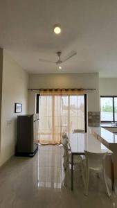 a kitchen and dining room with a table and chairs at Lucky Charm 2BHK Apartment - Muttukadu ECR in Chennai