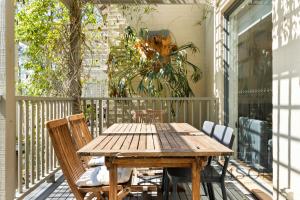 a wooden table and chairs on a porch at Two Bedroom Villa in The Hunter Valley in Pokolbin