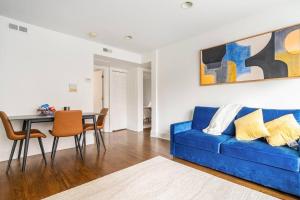 a living room with a blue couch and a table at Apartment by the lake in Chicago +23 photos