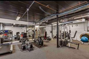 a gym with lots of equipment in a room at Apartment by the lake in Chicago