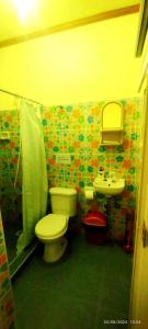 a bathroom with a toilet and a sink at L&L Beach Resort in Pandan