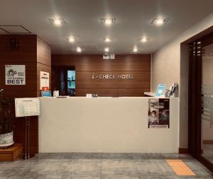 a lobby with a white counter and a check hotel at I-check Hyunjin Hotel in Donghae