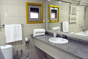 a bathroom with a sink and a toilet and a mirror at Karamürsel Mohti Otel Fitness Organizasyon in Karamusal