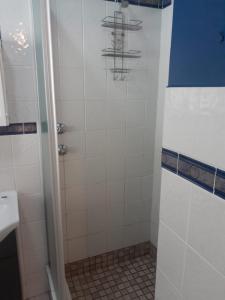 a shower in a bathroom with a tiled floor at La Corsica 9 in Margate