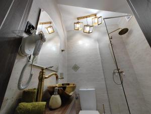 a bathroom with a sink and a shower and a toilet at Black&White House in Ocna-Mureşului +78 photos