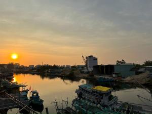 a group of boats docked in a harbor at sunset at Sông Hotel PQ - by BAY LUXURY in Phu Quoc