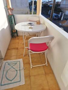 een kleine tafel en een stoel op een balkon bij Quarto Salvador in Laranjeira