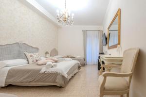 a bedroom with a bed and a desk and a piano at PALAZZO ALESSANDRINI GUEST HOUSE in Viterbo
