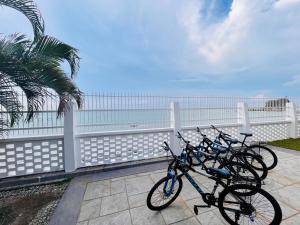 a row of bikes parked next to the beach at Seaview Mini Chalet - Direct Beach Access in Tanjung Bungah