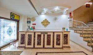 a room with a staircase and a counter in a building at Treebo Trend Paras International in New Delhi