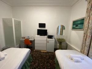 TV a/nebo společenská místnost v ubytování Aaran Central Guesthouse