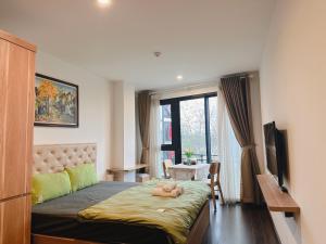 a bedroom with a bed with a doll laying on it at WINDY LAKEVIEW STUDIO HA NOI in Hanoi
