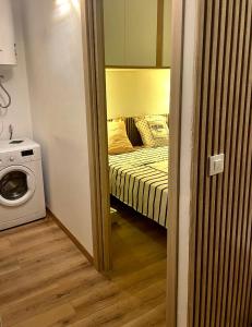 a small room with a bed and a washing machine at SANTA BEACH in Roses +28 photos