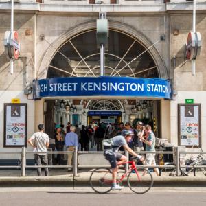 a man riding a bike in front of a station at Casa Italia near Kensington High Street - Wifi & Washing Machine in London