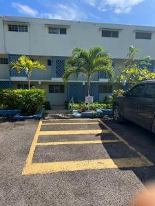 a car parked in a parking lot in front of a building at Carib condo in Ocho Rios