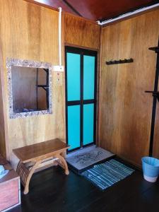 an empty room with a table and a window at The Station Tioman in Tioman Island