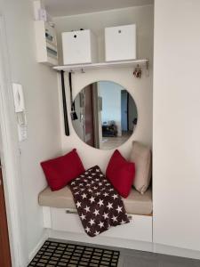 a small room with a couch and a mirror at Doktor Forselius gata 16 in Gothenburg