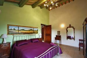 a bedroom with a purple bed and a mirror at Casale Vigneto in Mogliano +26 photos