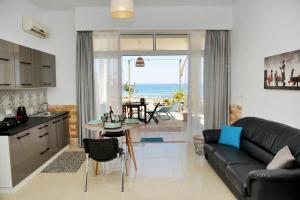 a kitchen and living room with a couch and a table at Studio Mare Faliraki in Faliraki