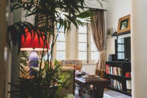 a living room with a couch and a plant at Bunker - The Suite in Ho Chi Minh City