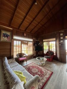 a living room with a couch and a table at Taverno Villa in Serang