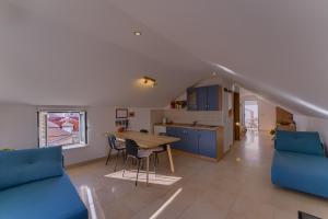 a kitchen and living room with a table and chairs at Guest House Dijana in Korčula