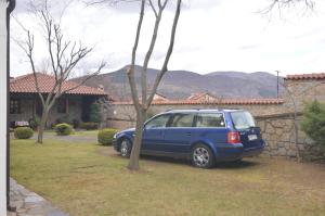 a blue car parked in front of a house at Villa Luxury Paradise Kastoria in Lithiá
