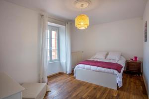 a white bedroom with a bed and a window at L'escapade Vendéenne - Grand jardin 4 chambres in Vix