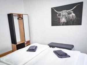 um quarto com uma cama com uma vaca na parede em großzügige Altstadtwohnung Lara für 6 Personen em Weißenfels