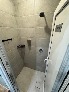 a shower with a glass door in a bathroom at Green Hostel Katowice 24h - Parking in Katowice