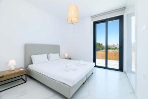 Krevet ili kreveti u jedinici u okviru objekta By The Beach - White Coral Villa