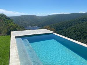 a swimming pool with a view of a mountain at Alkantmooi Private Nature Reserve - Keurkloof in Plettenberg Bay