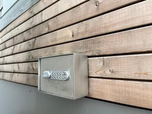 a metal box on the side of a wooden wall at Modernes Tiny Appartement in Lage in Lage