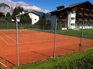 a tennis court in front of a building at Hotel Edelweiss in Innsbruck