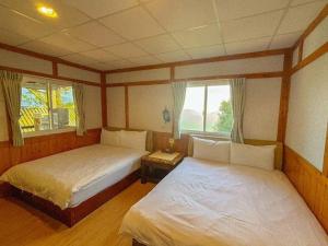 A bed or beds in a room at Zu Sin Garden B&B