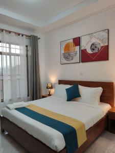 a bedroom with a large bed in a room at Wepick Homes in Kigali