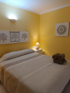 a bedroom with a large bed with yellow walls at Vera Natura Apartamento Paula in Vera