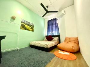 a room with a bed and a couch in it at Cozy 18 Entire 3 Bedroom @Alma Bukit Mertajam in Bukit Mertajam