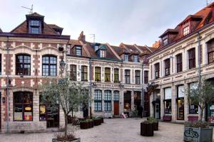 um grupo de grandes edifícios num pátio em Apartment in residence with balcony and parking em Lille