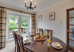 a dining room with a table and chairs and a window at Moraine in Ravenscar